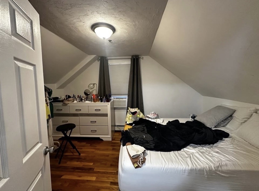 69 Beacon Street, Unit 3 Chelsea, MA 02150 - Photo 7 of 9 a bed room with a bed window and dresser