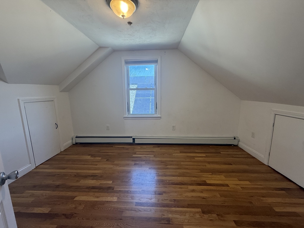 69 Beacon Street, Unit 3 Chelsea, MA 02150 - Photo 7 of 9 an empty room with wooden floor and windows