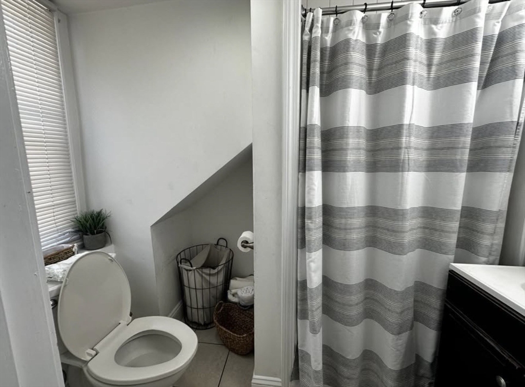 69 Beacon Street, Unit 3 Chelsea, MA 02150 - Photo 9 of 9 a white toilet sitting next to a bathroom sink
