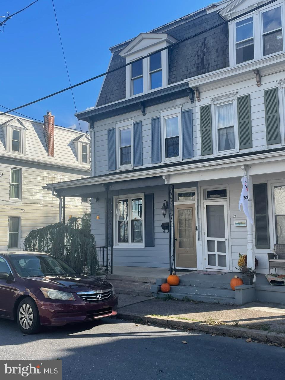 a view of a building with a large window and potted plants