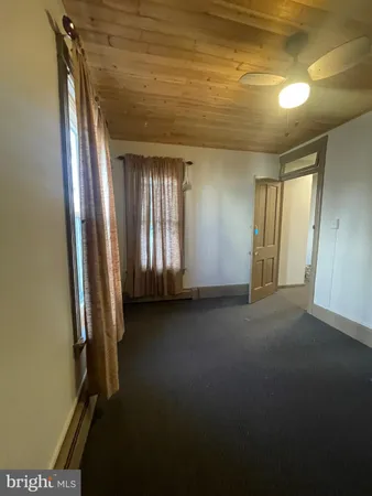 a view of an empty room and a window