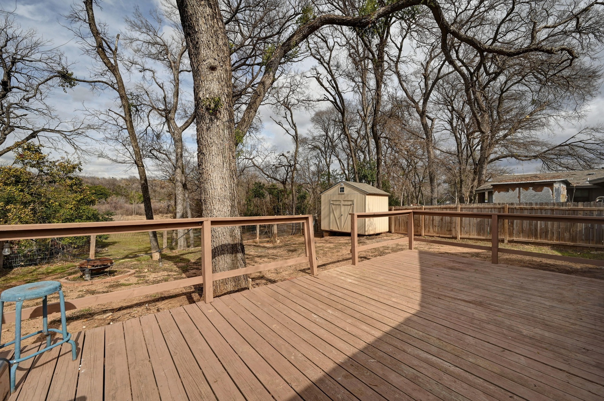 6302 Thurgood Avenue Austin, TX 78721 - Photo 19 of 28 Wooden deck with a shed, a fire pit, and a fenced backyard