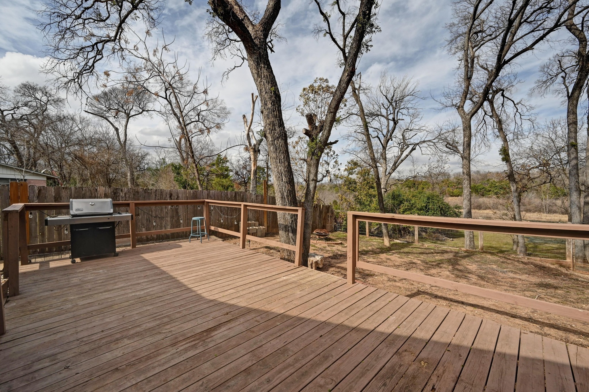 6302 Thurgood Avenue Austin, TX 78721 - Photo 20 of 28 Wooden deck with area for grilling and a fenced backyard