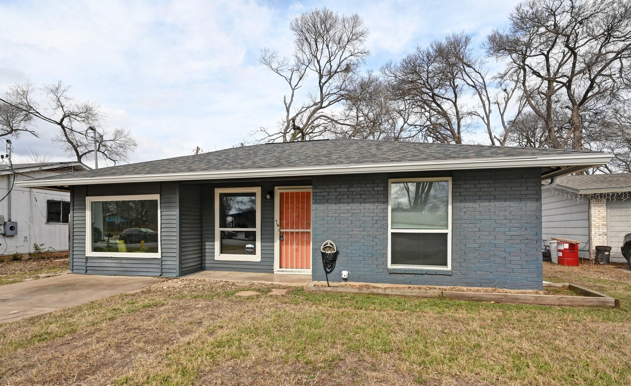 6302 Thurgood Avenue Austin, TX 78721 - Photo 3 of 31 a front view of a house with a yard and garage