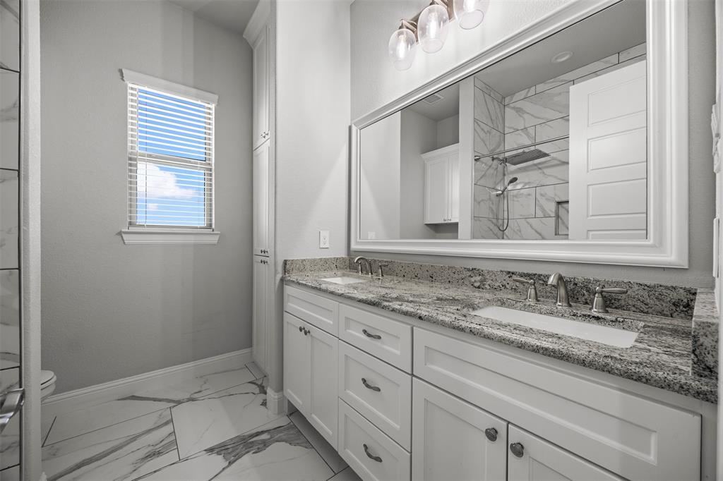 6381 Rigel Road Godley, TX 76044 - Photo 38 of 40 a bathroom with a sink and a mirror