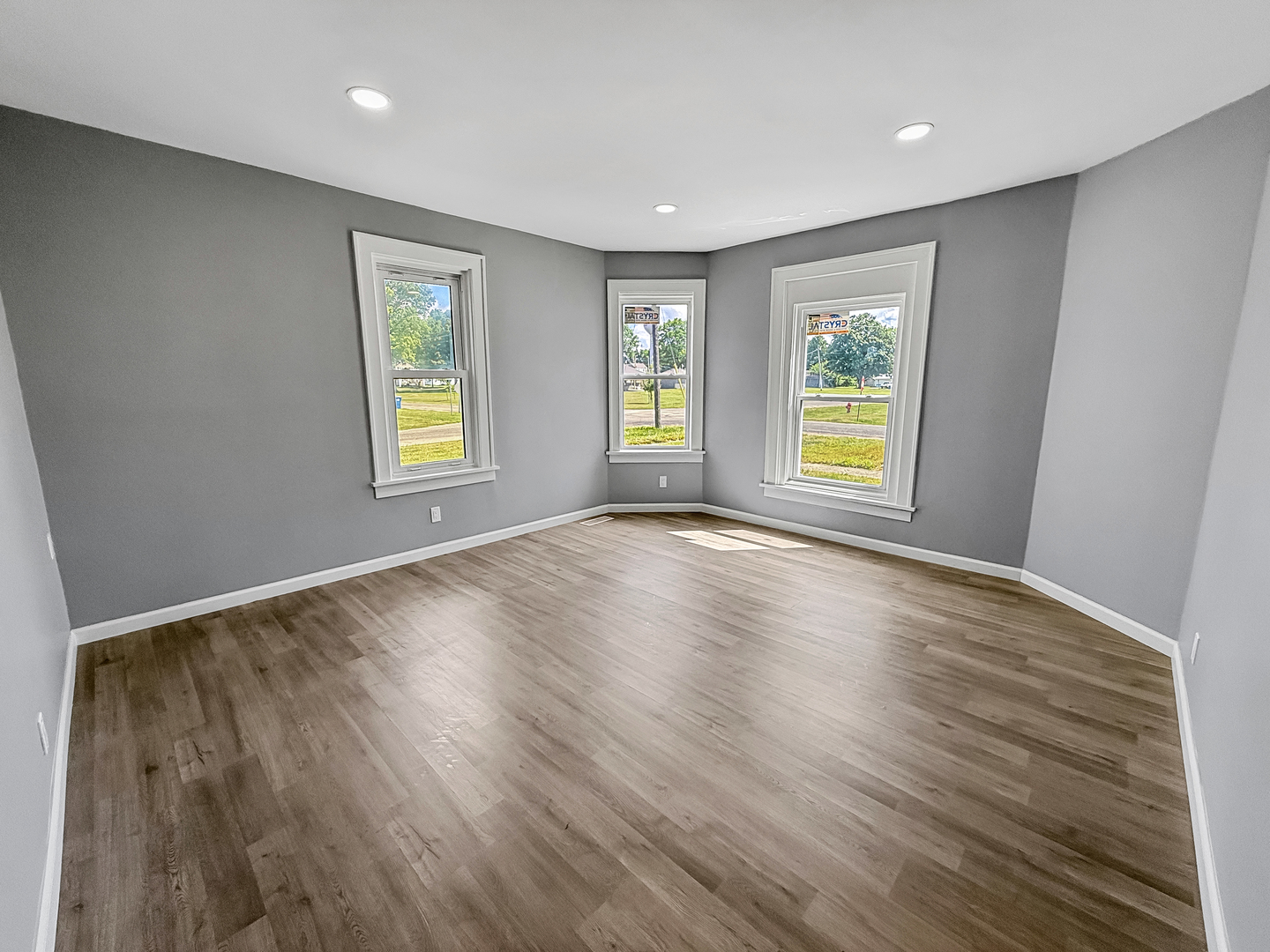 302 West Cook Street Sheffield, IL 61361 - Photo 9 of 18 a view of an empty room with wooden floor and a window