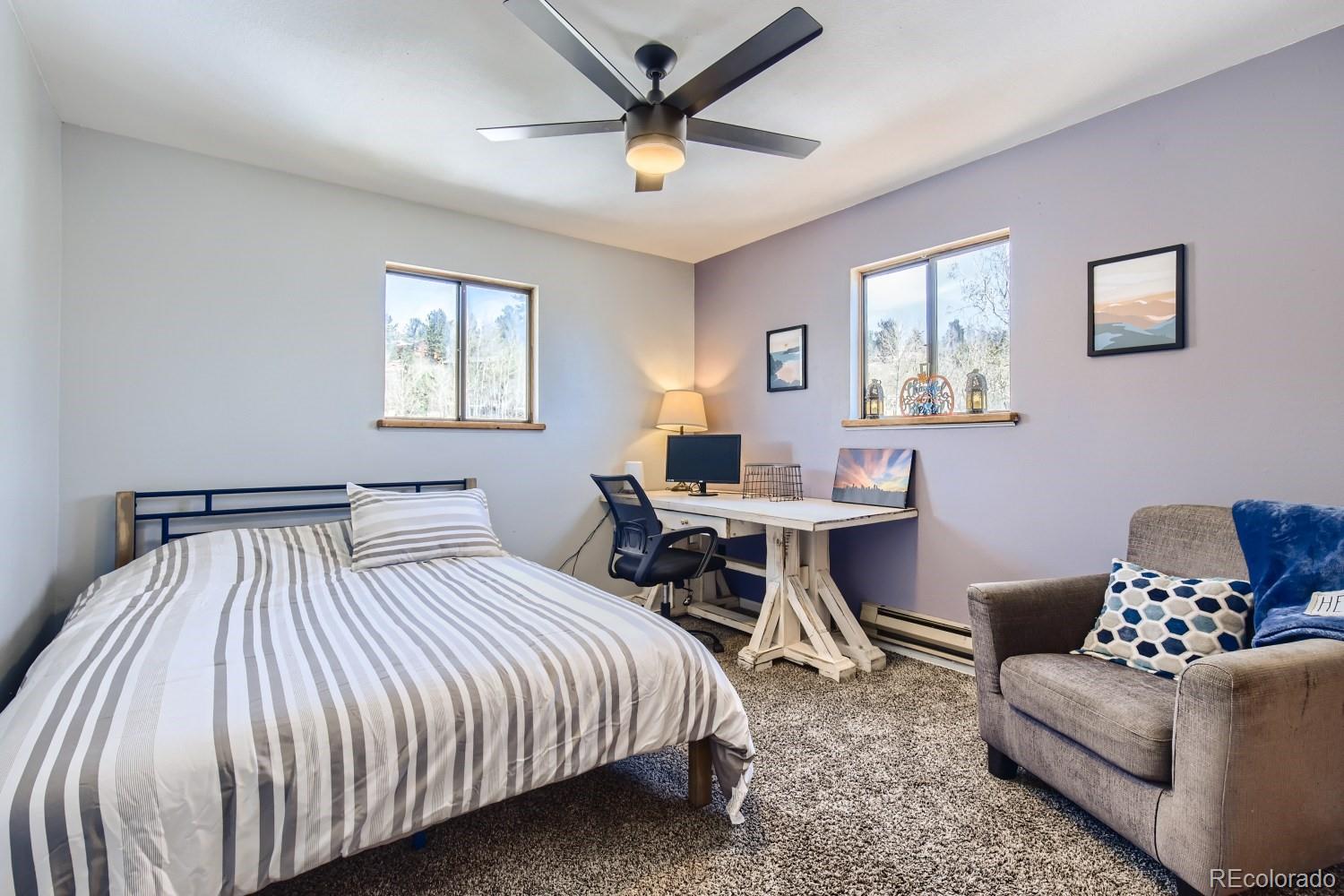 44 Bandit Lane Bailey, CO 80421 - Photo 16 of 30 a bedroom with a bed a couch and a window