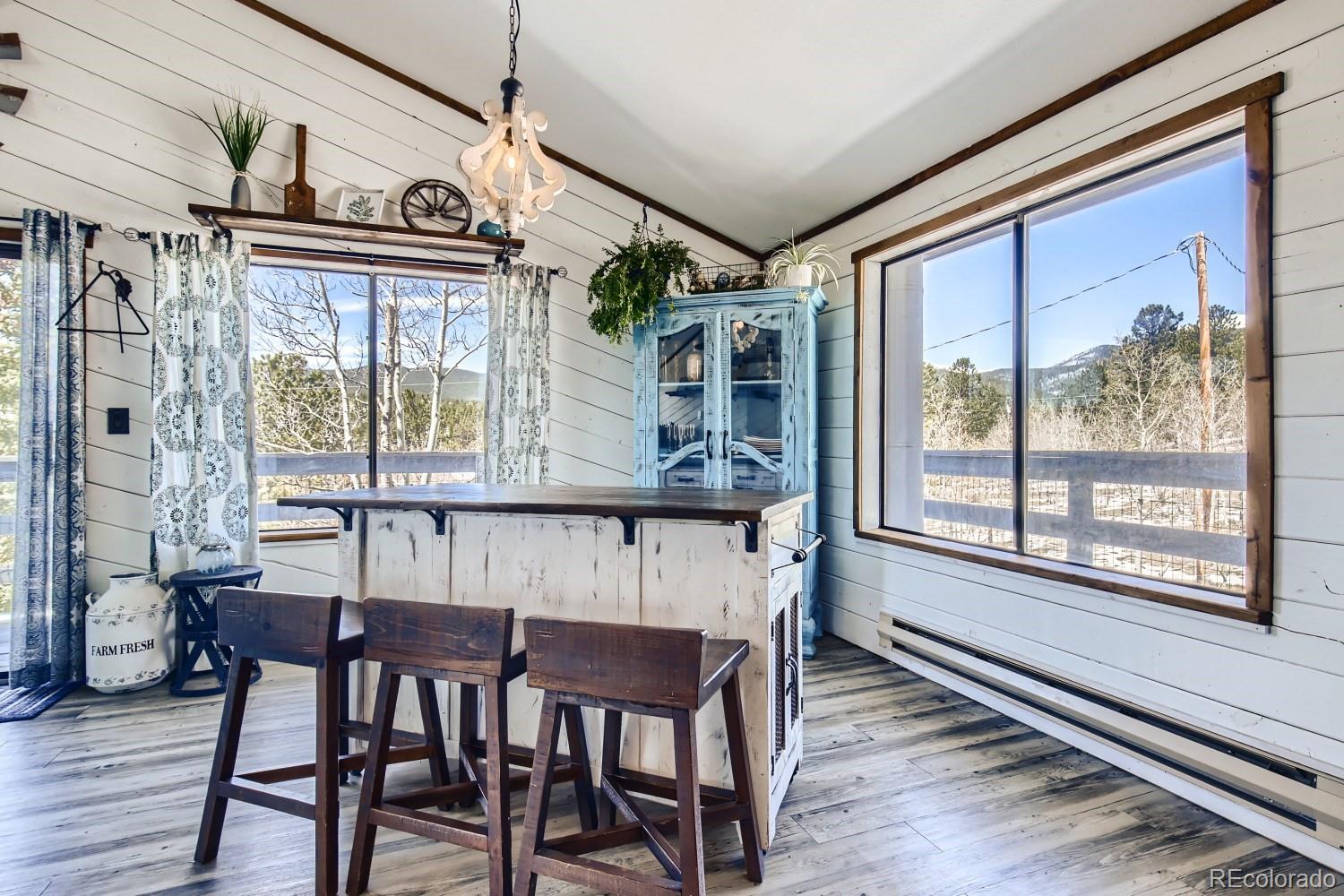 44 Bandit Lane Bailey, CO 80421 - Photo 17 of 30 a view of a dining room with furniture large window and wooden floor