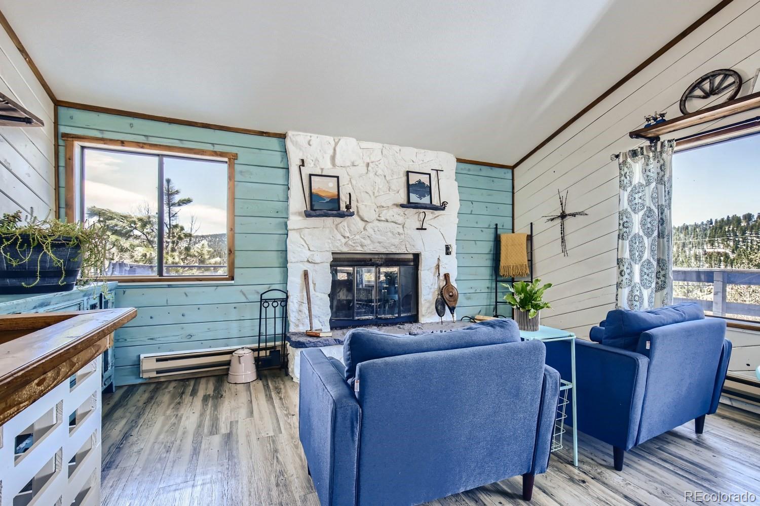 44 Bandit Lane Bailey, CO 80421 - Photo 19 of 30 a living room with furniture wooden floor and a fireplace