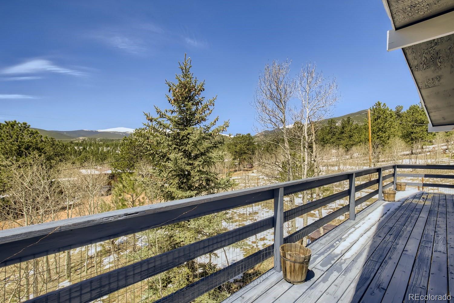 44 Bandit Lane Bailey, CO 80421 - Photo 22 of 30 a view of a balcony with wooden floor and a bench