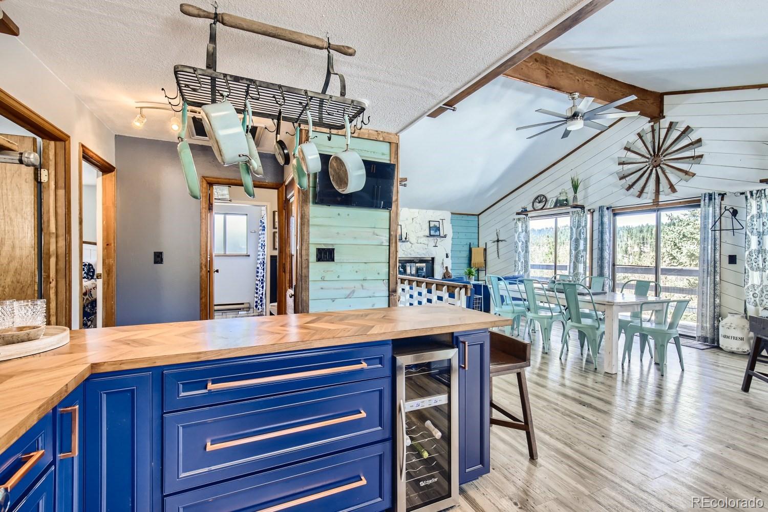 44 Bandit Lane Bailey, CO 80421 - Photo 3 of 30 a view of a dining room and livingroom with furniture wooden floor a chandelier