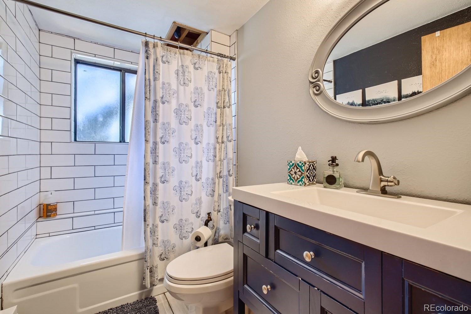 44 Bandit Lane Bailey, CO 80421 - Photo 10 of 30 a bathroom with a sink toilet a mirror and shower