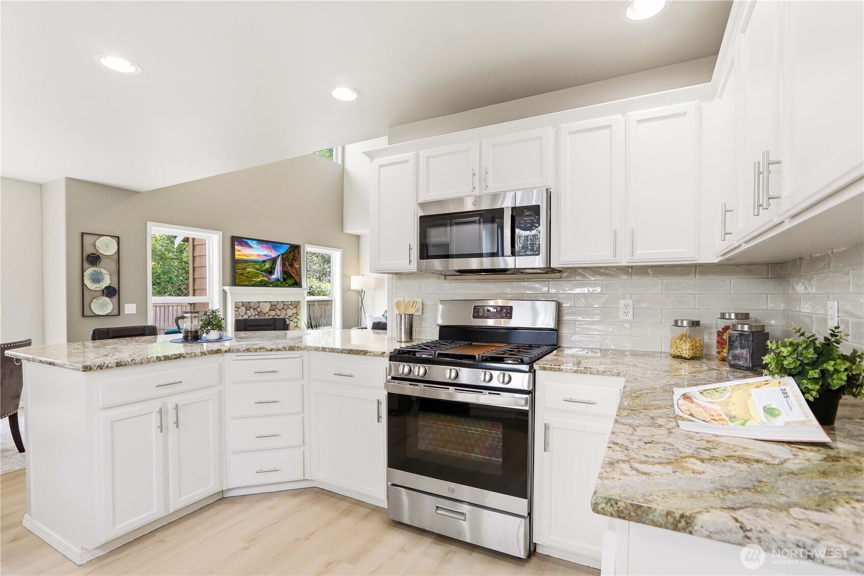 23327 8th Place West Bothell, WA 98021 - Photo 14 of 40 a kitchen with granite countertop a stove top oven microwave and cabinets
