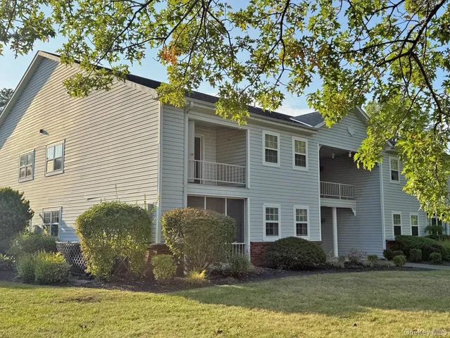 a front view of a house with a garden and plants