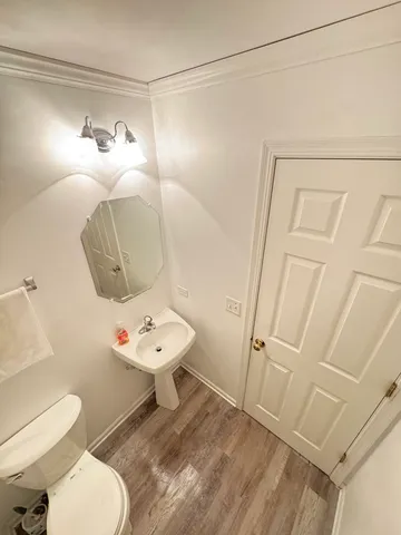a bathroom with a sink mirror vanity and toilet