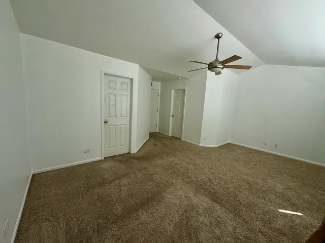 a view of a big room with a ceiling fan
