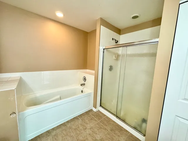 a bathroom with a bathtub and a shower