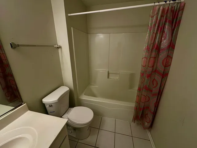 a bathroom with a toilet and shower