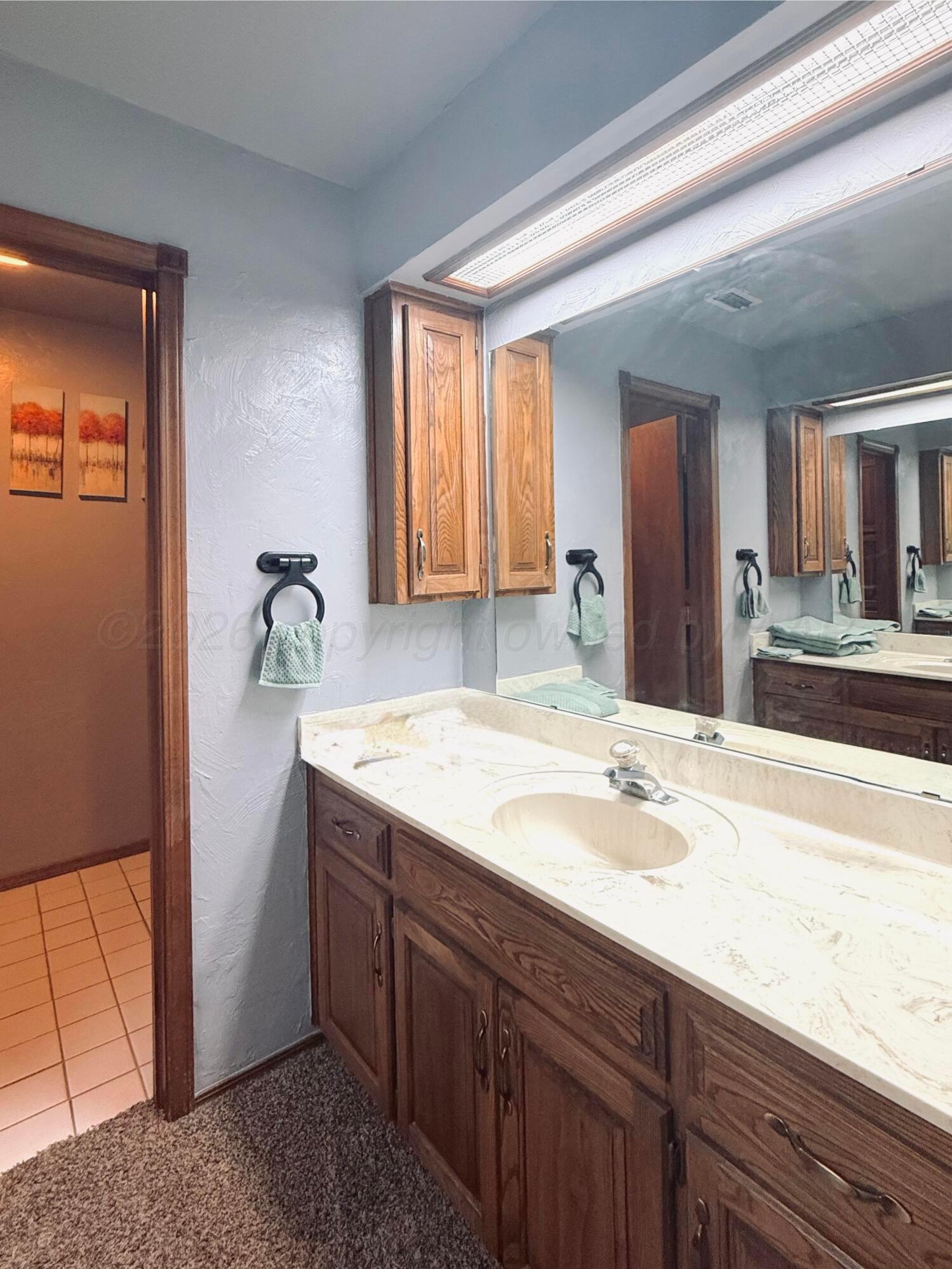 2005 Lister Street Borger, TX 79007 - Photo 12 of 20 a bathroom with a sink and a mirror