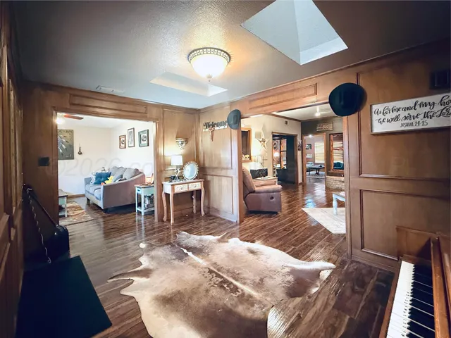 a living room with lots of furniture and a large window