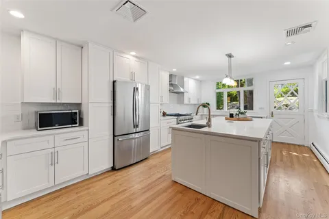 a kitchen with stainless steel appliances a refrigerator and a stove top oven