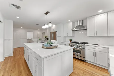 a kitchen with a sink stove and microwave