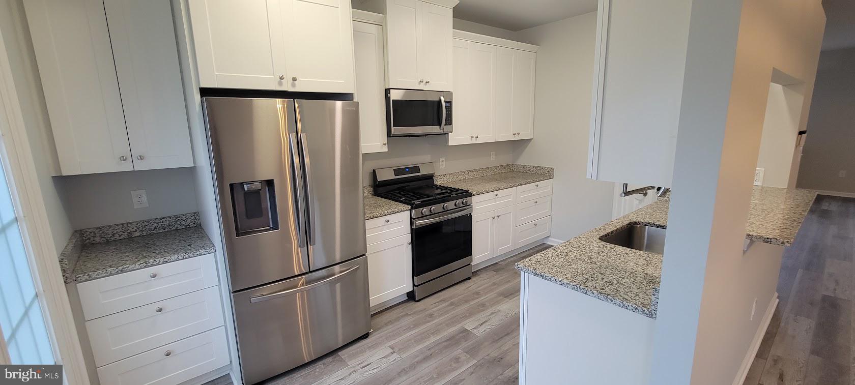 2246 Wetherburne Way Frederick, MD 21702 - Photo 4 of 23 Modern kitchen with sleek finishes.