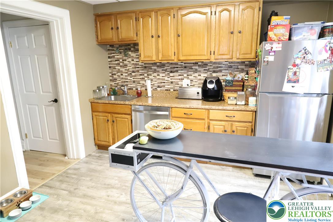 413 Pawnee Street Bethlehem, PA 18015 - Photo 7 of 16 a kitchen with stainless steel appliances granite countertop a sink and a stove