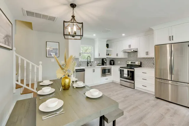 a kitchen with appliances and wooden floor