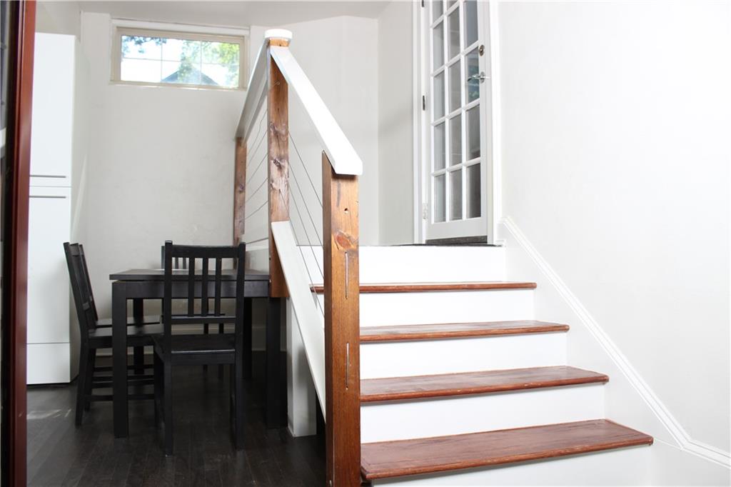 a view of entryway and hall with wooden floor