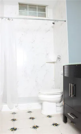 a bathroom with a toilet and a shower