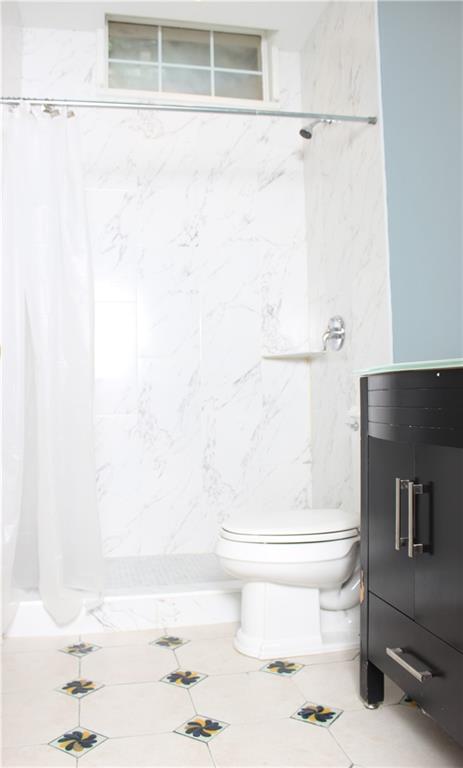 1124 Center Street Northwest Atlanta, GA 30318 - Photo 12 of 20 a bathroom with a toilet and a shower