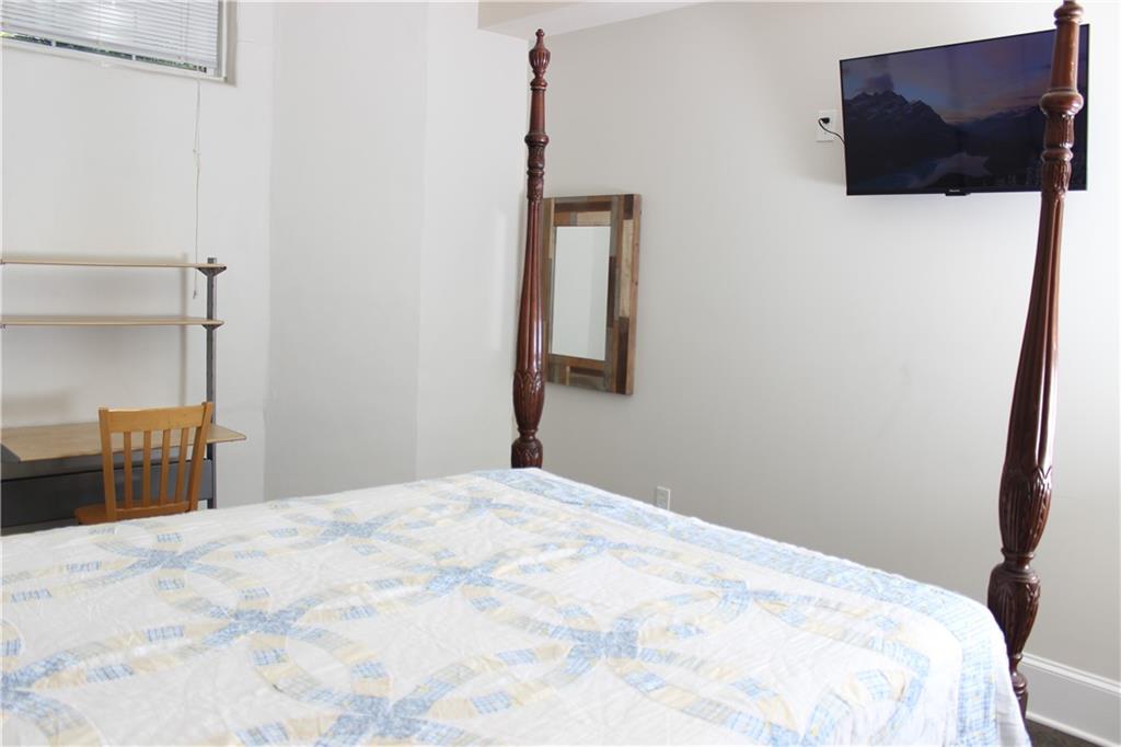 1124 Center Street Northwest Atlanta, GA 30318 - Photo 14 of 20 a bedroom with a bed and a flat screen tv