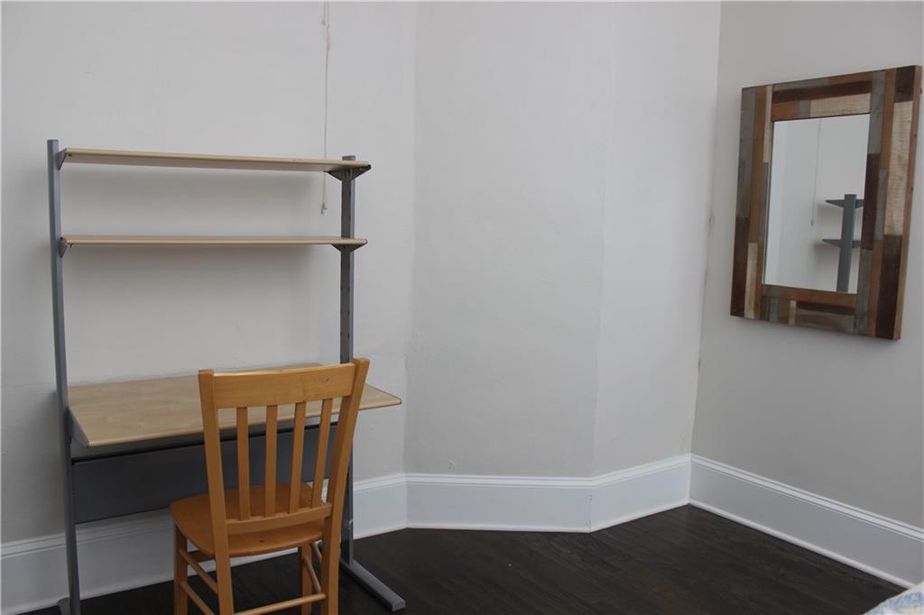 1124 Center Street Northwest Atlanta, GA 30318 - Photo 15 of 20 a view of a hallway with wooden floor and a cabinet