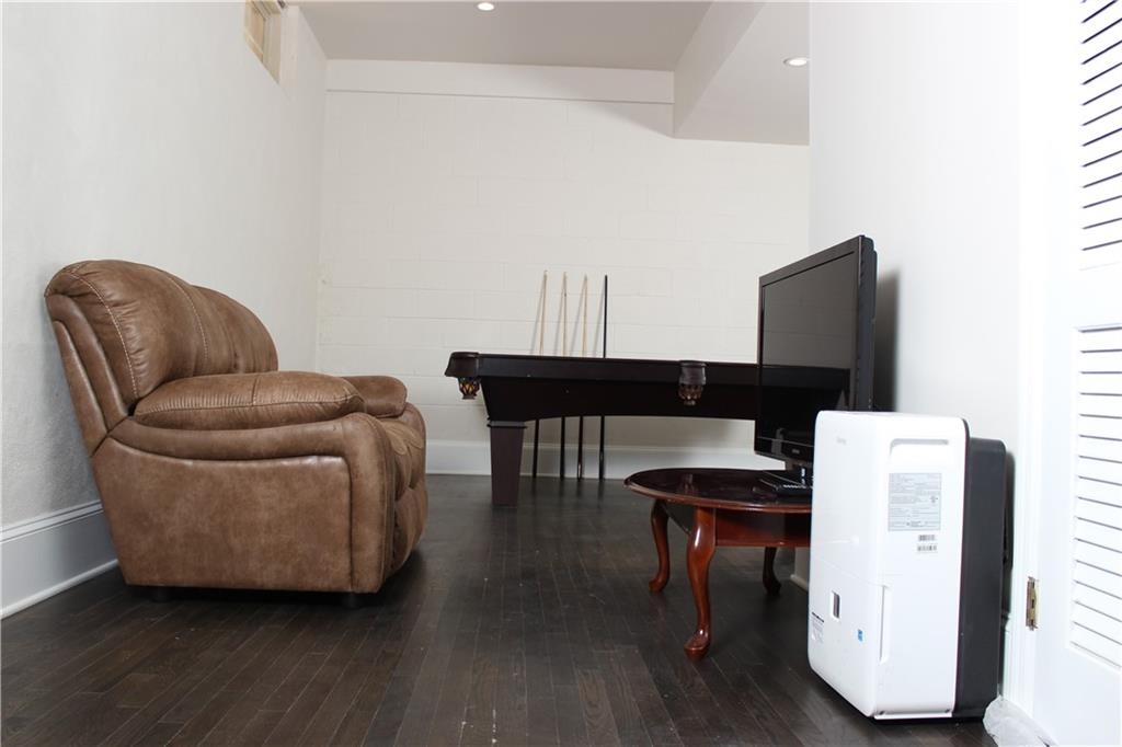 1124 Center Street Northwest Atlanta, GA 30318 - Photo 6 of 20 a living room with furniture and a wooden floor