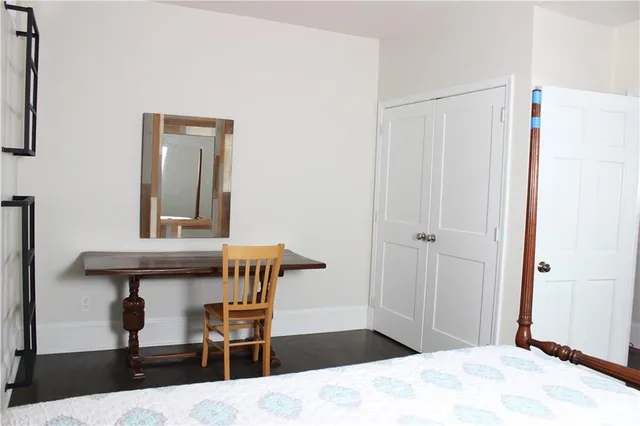 a bedroom with a bed and a table