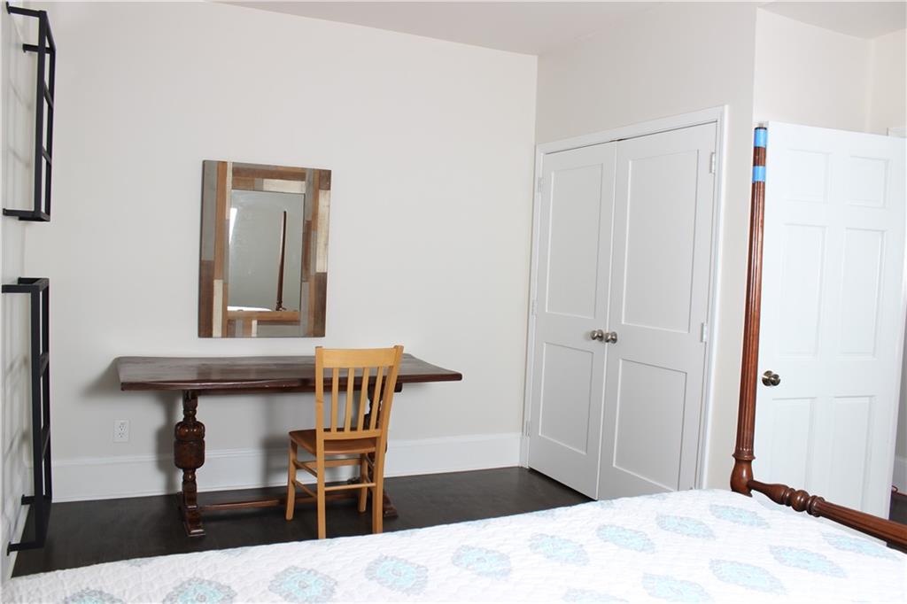 1124 Center Street Northwest Atlanta, GA 30318 - Photo 9 of 20 a bedroom with a bed and a table