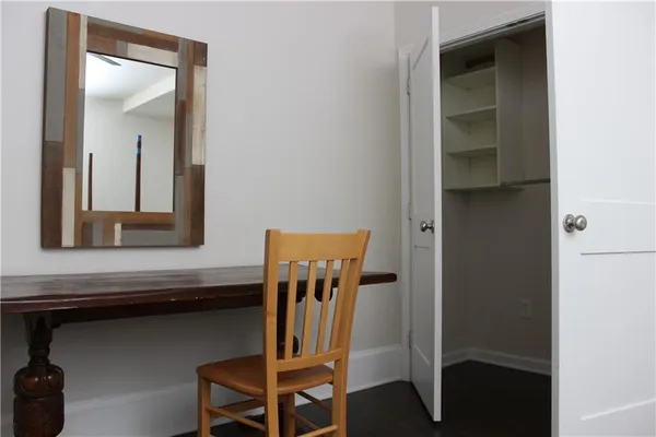 a view of hallway with chair and frames on wall
