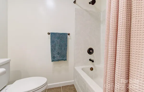 a bathroom with a bathtub a toilet a sink and a shower