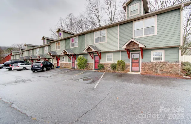 a view of a car park in front of a house