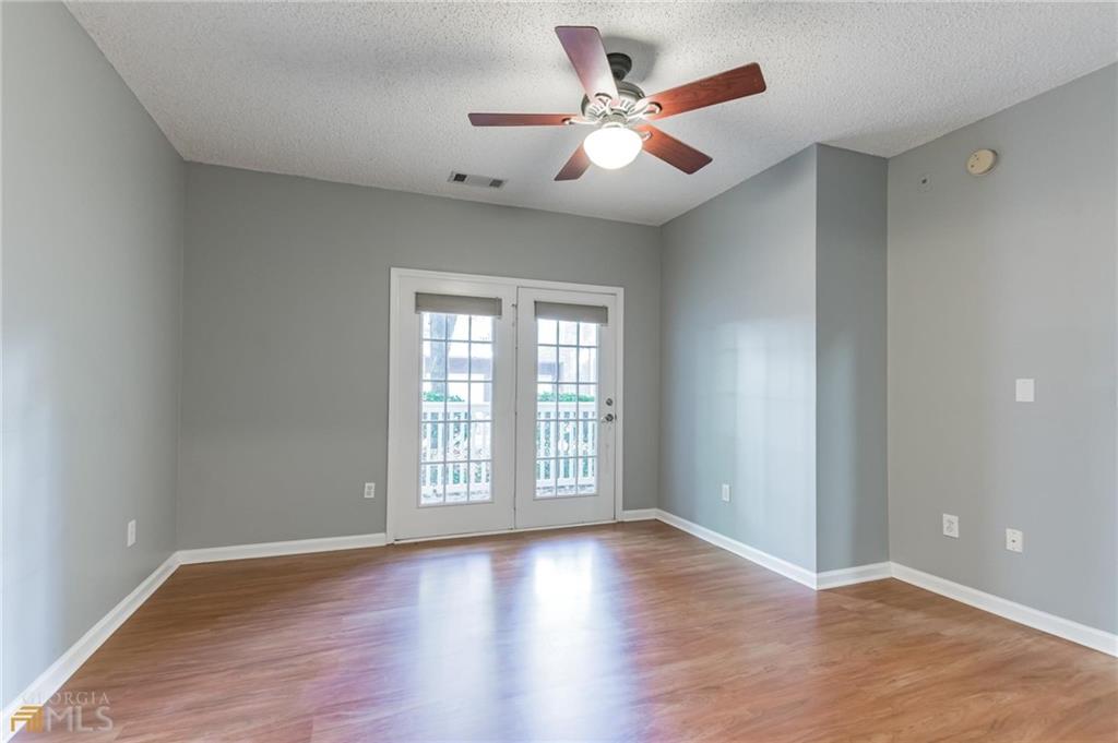 711 Spring Heights Lane, Unit 711 Smyrna, GA 30080 - Photo 11 of 30 wooden floor in an empty room with a window