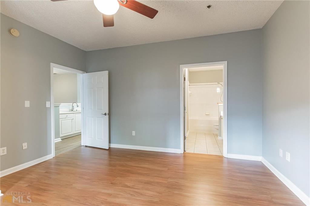 711 Spring Heights Lane, Unit 711 Smyrna, GA 30080 - Photo 12 of 30 wooden floor in an empty room with a window