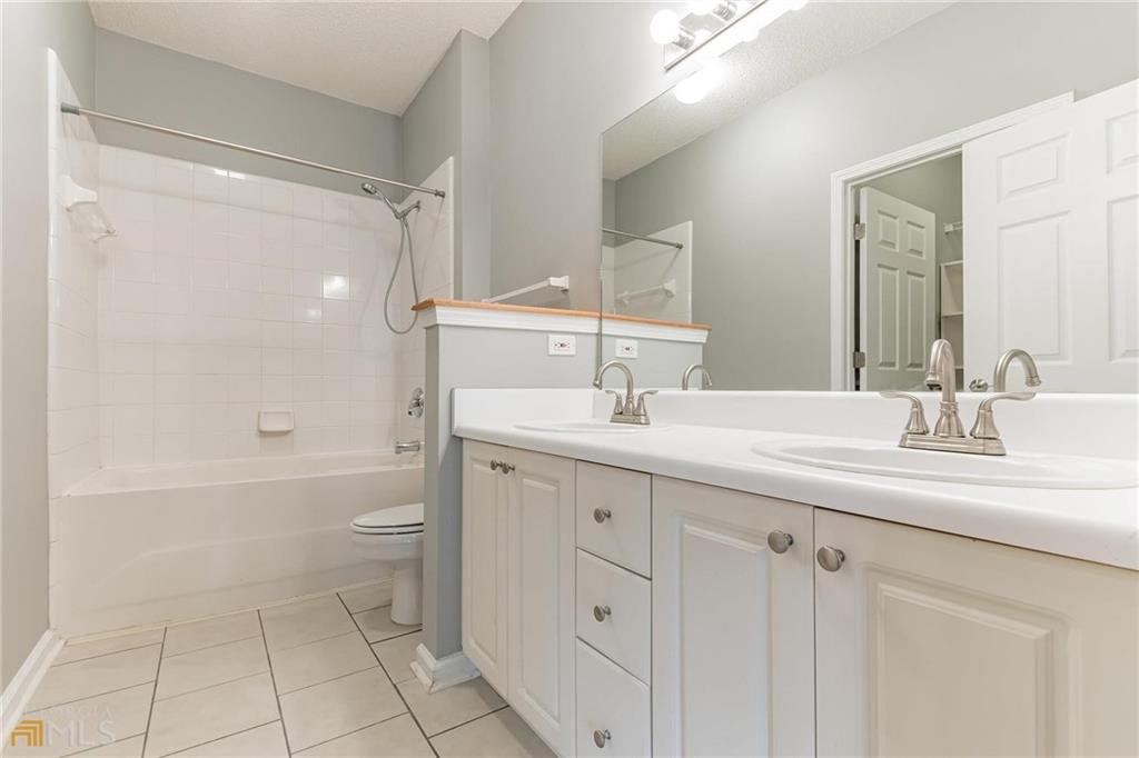 711 Spring Heights Lane, Unit 711 Smyrna, GA 30080 - Photo 13 of 30 a bathroom with a sink a toilet and shower