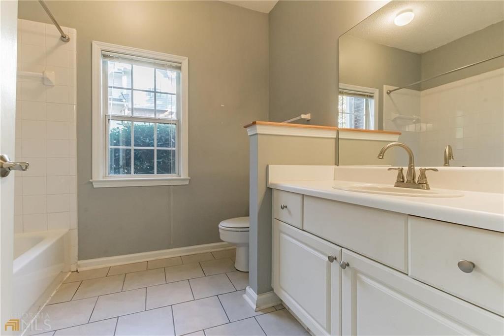 711 Spring Heights Lane, Unit 711 Smyrna, GA 30080 - Photo 18 of 30 a bathroom with a sink toilet and vanity
