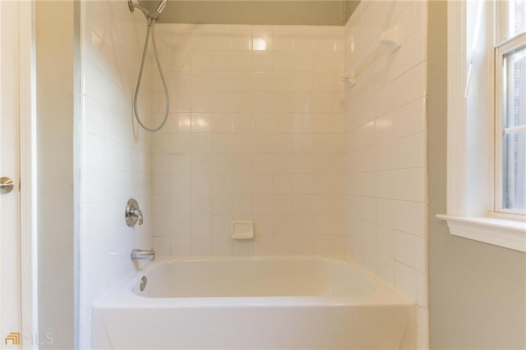 711 Spring Heights Lane, Unit 711 Smyrna, GA 30080 - Photo 19 of 30 a close up of a bathtub in a bathroom