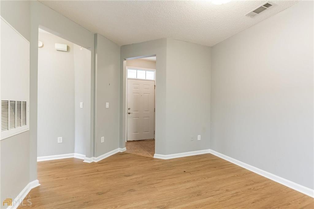 711 Spring Heights Lane, Unit 711 Smyrna, GA 30080 - Photo 2 of 30 an empty room with wooden floor and windows
