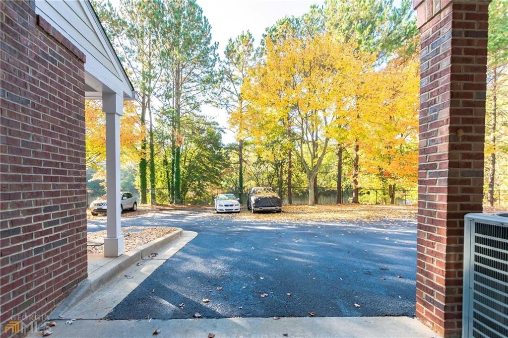 711 Spring Heights Lane, Unit 711 Smyrna, GA 30080 - Photo 22 of 30 a view of a patio with table and chairs and wooden fence
