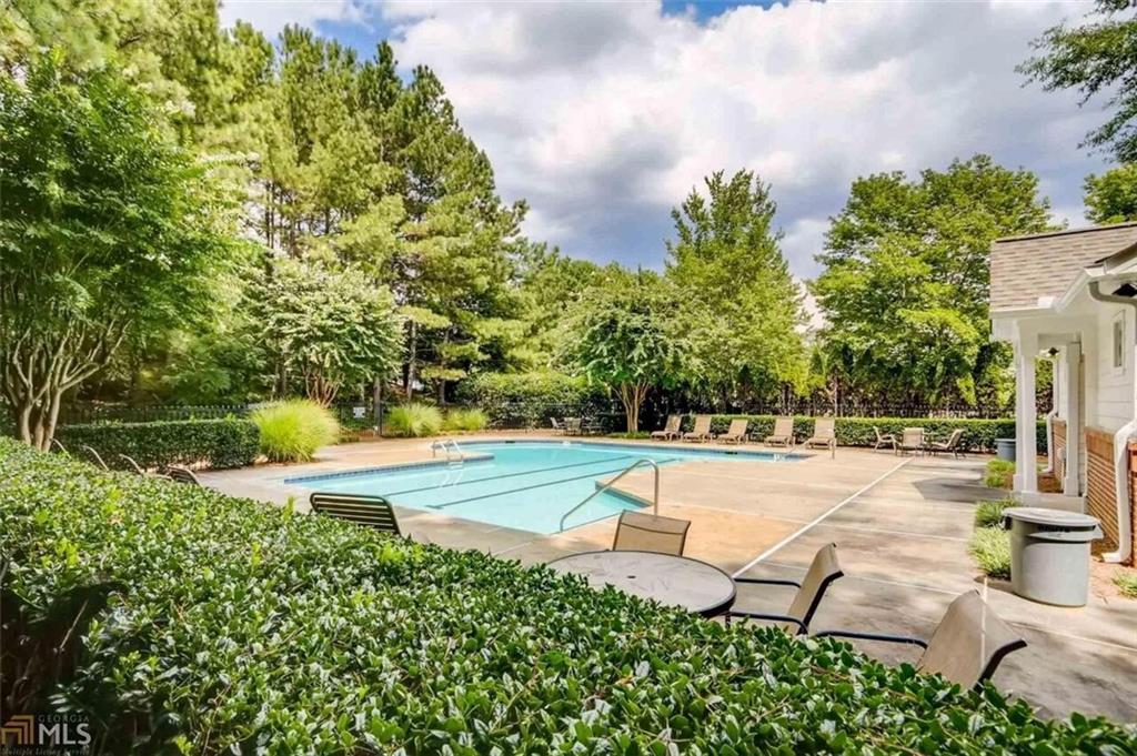 711 Spring Heights Lane, Unit 711 Smyrna, GA 30080 - Photo 24 of 30 a view of a swimming pool and lounge chairs