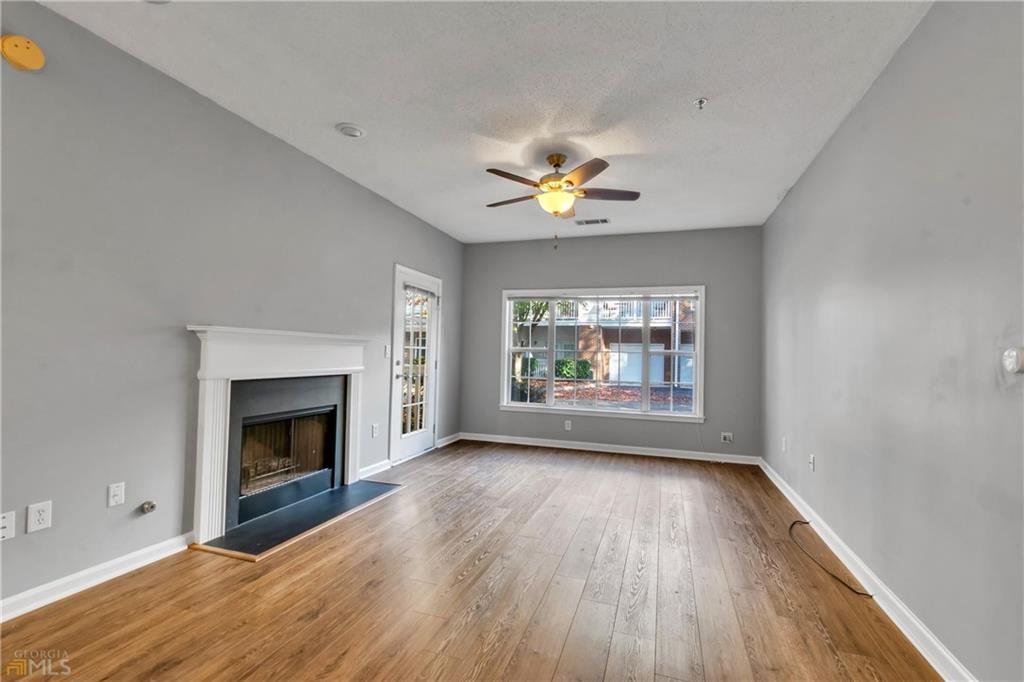 711 Spring Heights Lane, Unit 711 Smyrna, GA 30080 - Photo 4 of 30 an empty room with windows and fireplace