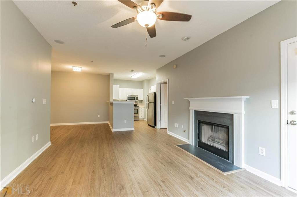 711 Spring Heights Lane, Unit 711 Smyrna, GA 30080 - Photo 5 of 30 a view of a livingroom with a fireplace a ceiling fan and wooden floor